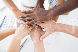 Business people joining hands in a circle