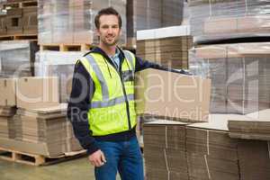 Worker carrying box in warehouse