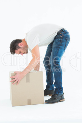 Delivery man picking cardboard box