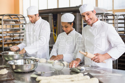 Team of bakers preparing dough