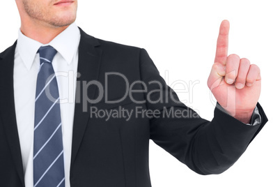 Unsmiling businessman pointing his finger