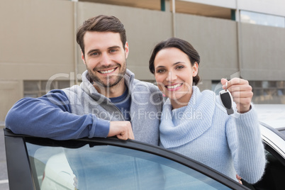 Young couple smiling holding new key Young couple smiling holding new key