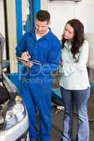 Mechanic and customer standing together