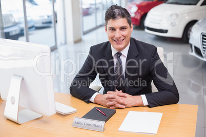 Happy businessman working at his desk