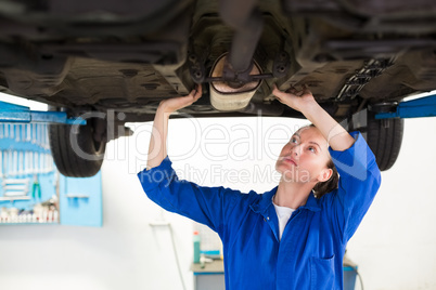 Mechanic examining under the car