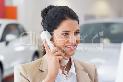 Smiling businessman making a phone call