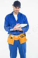 Portrait of repairman writing on document