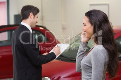 Smiling woman calling someone with her mobile phone