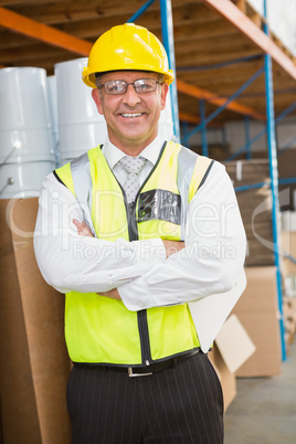 Manager wearing hard hat in warehouse