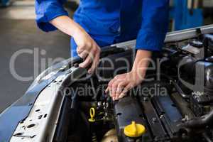 Mechanic working under the hood