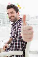 Positive casual businessman with thumbs up
