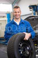 Mechanic holding a tire wheel