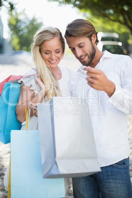 Attractive couple looking at shopping purchases