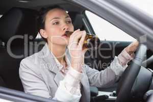 Woman drinking beer while driving