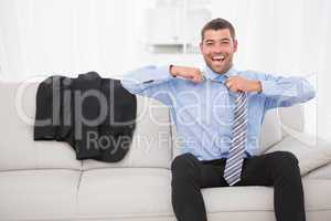 Businessman taking off his tie