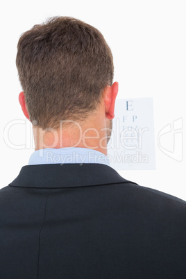 Focused man in suit on eye test letters