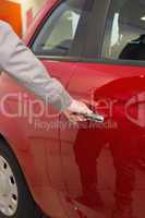 Man holding a car door handles
