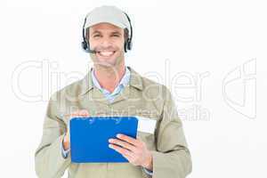 Delivery man in headphones holding clipboard