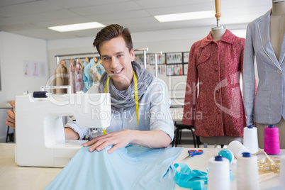 Smiling student using sewing machine