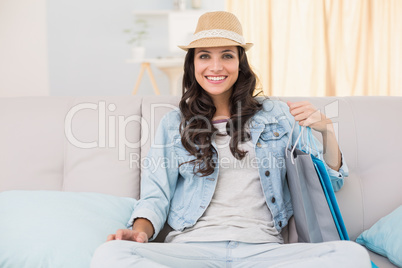 Pretty brunette looking at shopping bags