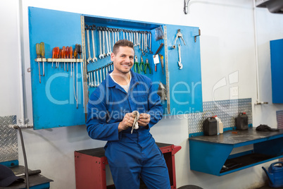 Smiling mechanic looking at camera