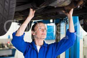 Mechanic examining under the car