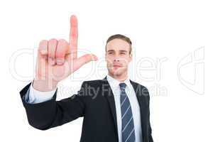 Unsmiling businessman in suit pointing up his finger