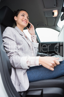 Businesswoman working in the drivers seat