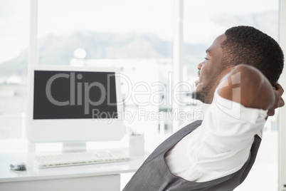 Relaxed businessman with hands behind head