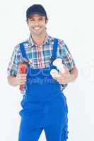 Plumber holding monkey wrench and sink pipe