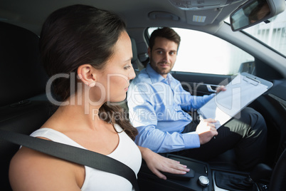 Young woman getting a driving lesson