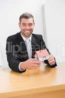 Businessman holding a house model