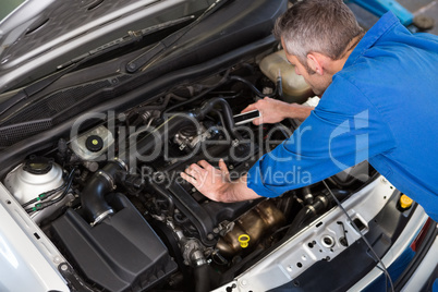 Mechanic working under the hood