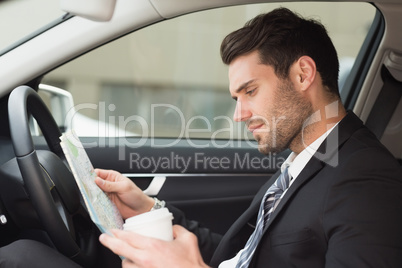 Young businessman reading a map