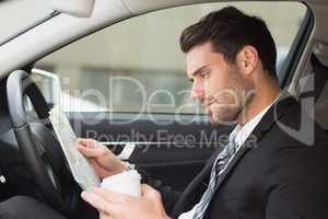 Young businessman reading a map