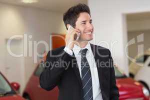 Smiling businessman calling with his mobile phone