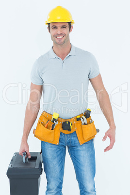 Confident technician holding tool box