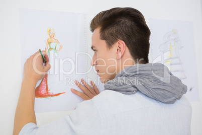 Fashion student drawing pictures on paper