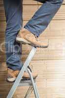 Worker on ladder in warehouse