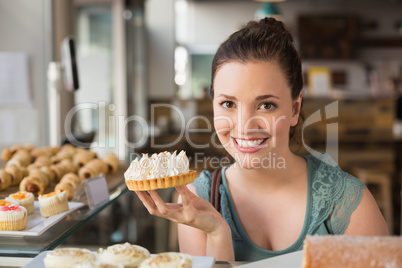 Pretty brunette holding lemon meringue pie