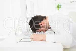 Exhausted businessman napping on keyboard