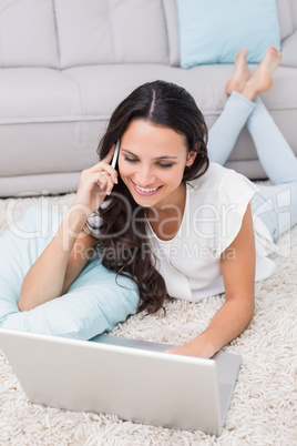 Pretty brunette using her laptop