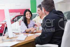 Salesman giving car keys to a couple