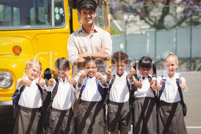 Cute pupils with their school bus driver