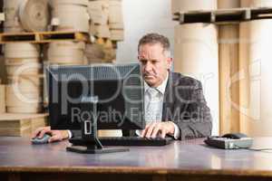 Warehouse manager working on computer