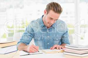 Casual businessman studying at his desk