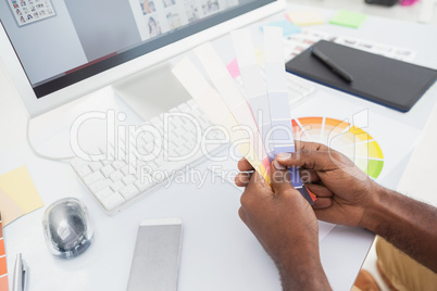 Designer holding colour sample and choosing