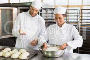 Team of bakers preparing dough