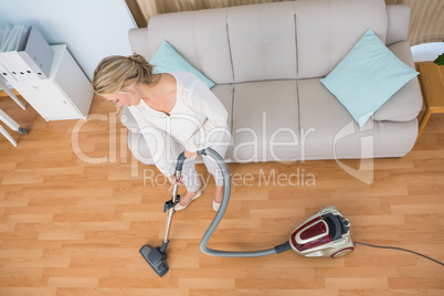 Disinterest woman cleaning her living room