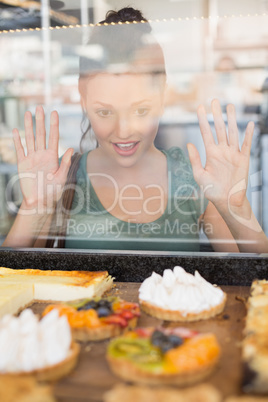 Pretty brunette looking at pastrys